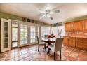 Sunlit dining space featuring tan tile flooring and wooden cabinets, creating a warm atmosphere at 4730 Mountain Valley Rd, Las Vegas, NV 89121