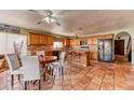 A view of a warm eat-in kitchen with tile floors and natural wood cabinets at 4730 Mountain Valley Rd, Las Vegas, NV 89121
