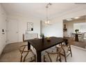 Elegant dining room features a wooden table, stylish chairs, modern light fixture, and tasteful decor at 4790 E Cleveland Ave, Las Vegas, NV 89104