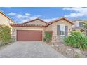Charming home showcasing a two car garage, rock accents and desert landscaping at 5344 Bocopa St, Las Vegas, NV 89148