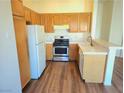 Bright and airy kitchen with stainless steel appliances and tile countertops at 5406 Indigo Hills St, North Las Vegas, NV 89031