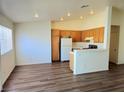 Bright, open-concept living room featuring wood flooring and natural light at 5406 Indigo Hills St, North Las Vegas, NV 89031