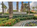 Beautiful Innisbrook community entrance featuring lush greenery, flowerbeds, and mature palm trees at 60 Innisbrook Ave, Las Vegas, NV 89113