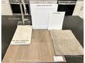 Kitchen features Sleek Stainless faucet with white Elkins cabinets, vinyl plank, and carpet samples at 9059 Rivington Ave, Las Vegas, NV 89148