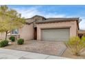 Charming single-story home featuring a brick driveway and a two-car garage at 907 Gallery Course Dr, Las Vegas, NV 89148
