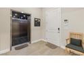 An elevator and doorway provide access to a bright entryway, complemented by a chair at 9144 Las Manaitas Ave # 201, Las Vegas, NV 89144