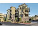 A striking building featuring multiple floors, balconies, and manicured greenery along the sidewalk at 9144 Las Manaitas Ave # 201, Las Vegas, NV 89144