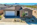 Charming single-story home featuring a two-car garage, desert landscaping and a mountain view at 1005 Warsaw Ave, Henderson, NV 89015