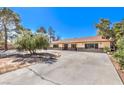 Attractive single-story home featuring a spacious driveway and a beautifully landscaped front yard, ideal for entertaining at 10615 Rancho Destino Rd, Las Vegas, NV 89183