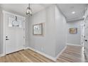 Inviting entryway with wood flooring, fresh paint, and stylish light fixture at 1395 Logandale Dr, Logandale, NV 89021