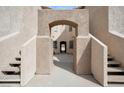 Exterior shot featuring a stucco facade and an arched entry to a courtyard at 1851 Hillpointe Rd # 2412, Henderson, NV 89074