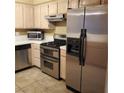 Open kitchen with stainless steel appliances including a microwave, stove, oven, and a large refrigerator at 1851 Hillpointe Rd # 2412, Henderson, NV 89074