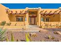 Inviting front entrance with desert landscaping, stone walkway, and detailed trim at 2201 Rosanna St, Las Vegas, NV 89117
