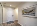 Inviting entryway featuring wood-look flooring and artwork at 2583 Moonlight Valley Ave, Henderson, NV 89044