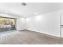 Bedroom with new carpet, neutral walls, and sliding door to balcony at 2606 S Durango Dr # 287, Las Vegas, NV 89117