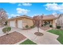 Single-story home with a three-car garage, walkway, and neat landscaping at 2763 Morning Meadow Ct, Las Vegas, NV 89156