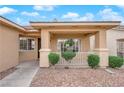 Inviting covered porch with decorative pillars and manicured shrubbery at 2763 Morning Meadow Ct, Las Vegas, NV 89156
