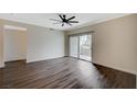 Bright living room with dark wood flooring and a sliding glass door leading to a private patio at 2900 Sunridge Heights Pkwy # 518, Henderson, NV 89052