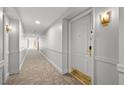 Hallway view of condo number 409 showing doors and carpeted floors at 30 Strada Di Villaggio # 409, Henderson, NV 89011