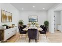 Elegant dining room with a white table, velvet chairs, and modern decor at 311 S Lisbon St, Henderson, NV 89015