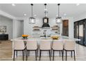 Modern kitchen with a large island, pendant lighting, and stainless steel appliances at 311 S Lisbon St, Henderson, NV 89015