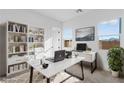 Bright office featuring a large desk, ample storage, and two windows for natural light at 311 S Lisbon St, Henderson, NV 89015
