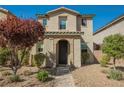 Front view of the house with manicured landscaping and a charming entrance at 3158 Teaderman Walk, Henderson, NV 89044