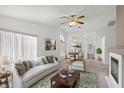 Bright living room with fireplace, ceiling fan, and elegant furnishings at 3643 Spring Willow Ct, Las Vegas, NV 89147