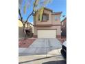 Two-story home boasts an attached garage and low-maintenance landscaping at 3805 Carisbrook Dr, North Las Vegas, NV 89081