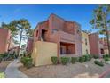 Multi-level apartment complex features a unique architectural style and well-maintained landscaping at 4050 Pacific Harbors Dr # 233, Las Vegas, NV 89121