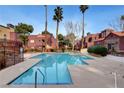 Community pool featuring clear blue water, lounge chairs, and nearby seating areas at 4050 Pacific Harbors Dr # 233, Las Vegas, NV 89121