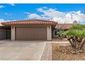 Charming single story home featuring a brown two-car garage and a desert landscape with gravel and a decorative palm at 436 Concord Way, Henderson, NV 89015