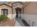 Charming entrance with stone archway and black front door at 4632 Cantina Rey St, North Las Vegas, NV 89081