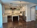 Spacious kitchen features white cabinetry, stainless steel appliances, and center island at 4912 Capo Gallo St, Las Vegas, NV 89130