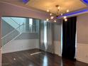 Inviting living room with modern lighting, hardwood floors, and elegant staircase at 4912 Capo Gallo St, Las Vegas, NV 89130