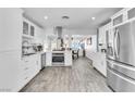 Bright white kitchen with stainless steel appliances and ample counter space for meal preparation at 5582 Tunis Ave, Las Vegas, NV 89122