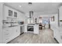 Well-lit kitchen with white cabinets, stainless steel appliances, and a view to the dining area at 5582 Tunis Ave, Las Vegas, NV 89122