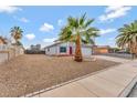 Charming home displays desert landscaping, a spacious driveway, and a two-car garage at 5815 Christchurch Ave, Las Vegas, NV 89110