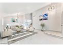 Open-concept living room boasts high ceilings, elegant lighting, and neutral decor at 5815 Christchurch Ave, Las Vegas, NV 89110