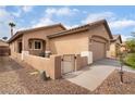Charming single-story home with desert landscaping, a gated front entry, and an attached two-car garage at 5991 Saddle Horse Ave, Las Vegas, NV 89122