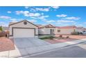 A lovely one-story home with a two-car garage, desert landscaping, and a concrete driveway at 629 Majestic Sky Dr, North Las Vegas, NV 89031