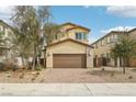 Inviting two-story home with a two-car garage, low-maintenance desert landscaping and brick paved driveway at 6622 Palm Branch St, North Las Vegas, NV 89086