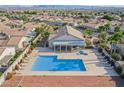 Enjoy the community pool with lounge chairs and a covered patio area for relaxing at 6684 Black Oil Dr, Las Vegas, NV 89122