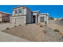Charming two-story home featuring a three-car garage and desert-style landscaping at 7900 Holly Knoll Ave, Las Vegas, NV 89129