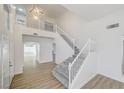 Bright, open foyer with high ceilings, staircase, and wood-look flooring at 7900 Holly Knoll Ave, Las Vegas, NV 89129
