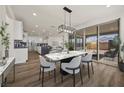 Open-concept dining room features modern light fixture and sliding doors to outdoor space at 8106 Skye Glen St, Las Vegas, NV 89166