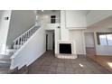 Bright and airy living room with a fireplace, lots of natural light, and tile flooring at 8166 Tone St, Las Vegas, NV 89123