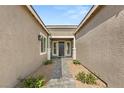 Charming front entrance with brick pathway and landscaped garden at 9930 Zakos Ct, Las Vegas, NV 89149