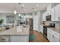 Bright kitchen with white cabinets, stainless steel appliances, and granite countertops at 9983 Cluny Ave, Las Vegas, NV 89178