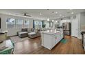 Spacious living room with a large sectional sofa and a modern ceiling fan at 9983 Cluny Ave, Las Vegas, NV 89178